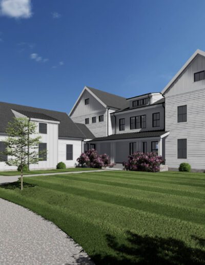 A large modern farmhouse with white siding, dark windows, gable roofs, surrounded by green lawn, shrubs, and bushes, under a blue sky with some clouds.