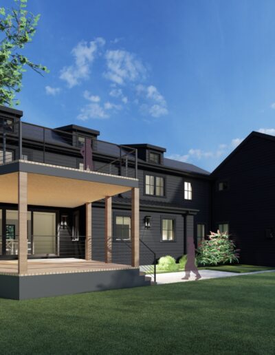 Modern two-story black house with large windows, a covered deck with railings, and a spacious green lawn, set against a backdrop of trees and a clear blue sky.